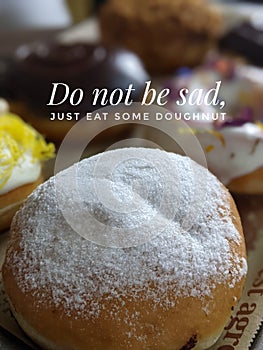 motivational quote with doughnut blurred background. Do not be saf. Just eat some doughnut