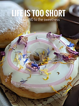 motivational quote with doughnut blurred background.  Life is too short to say no to the sweetness