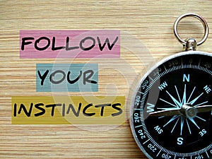 Motivational quote `Follow Your Instincts`.