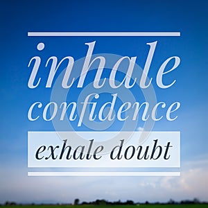 A motivational quote, "INHALE CONFIDENCE EXHALE DOUBT" isolated on blue sky landscape.
