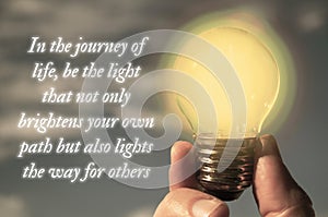 Motivational quote about journey of life with closeup light bulb background