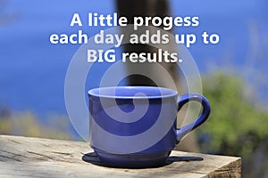 Motivational quote - A little progress each day adds up to big results. With a cup of coffee on table on blue beach background.