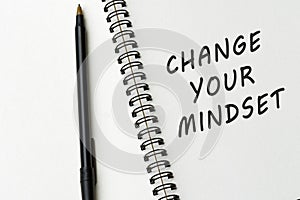 Motivational quote on notepad - Change your mindset.