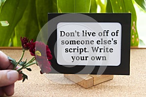 Motivational quote text on notepad - Don't live off of someone else's script. Write your own. Motivational