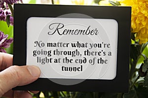 Motivational quote text on notepad - No matter what you& x27;re going through, there& x27;s a light at the end of the