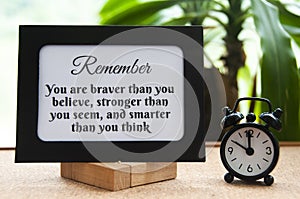 Motivational quote text on notepad - You are braver than you believe, stronger than you seem, and smarter than you think