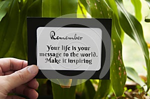 Motivational quote text on notepad - Your life is your message to the world. Make it inspiring.