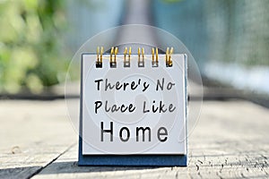 Motivational quote on white note - There's No Place Like Home.