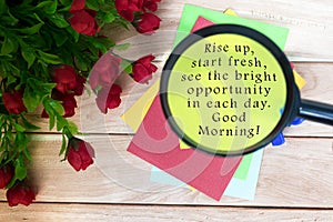 Motivational quote on written on colorful notepad with magnifying glass.