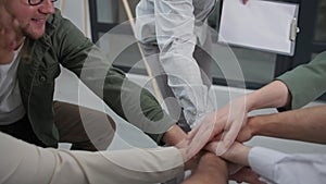 motivational speaker, young man conducts successful training with group of people gathers their hands in circle and