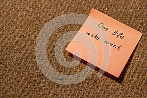 Motivational sticky note with inspiring message on textured surface photo