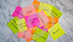 Motivational words on colorful stickers on a marble table. Business plan, strategy, concept, future. Copy space, creativity,