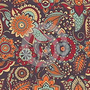 Motley oriental paisley seamless pattern with colorful buta motif and mehndi elements on dark background. Bright colored