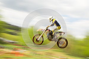 Motocross bike rider jumping in motion
