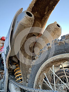 Motocross Dirt bike in back of truck all muddy and dirty