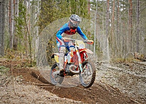 Motocross driver accelerating the motorbike on the race track