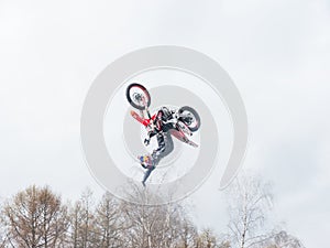 Motocross freestyle rider One Hand Back Flip jump