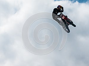 Motocross freestyle rider One Hand Hello Whip jump