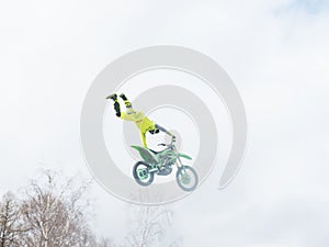 Motocross freestyle rider One Hand Tail Grab jump
