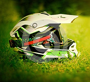 Motocross helmet with goggles on grass