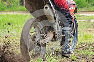 Motocross. Motorcyclist rushes along a dirt road, dirt flies from under the wheels.