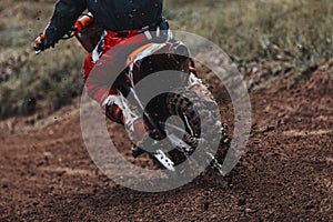 Motocross, pieces of dirt flying off the bike, off-road motorbike races, rear view