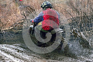 Motocross racer accelerating in dirt track