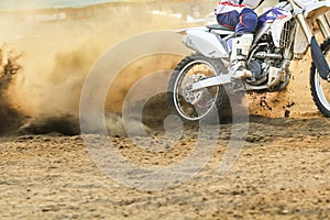 Motocross racer accelerating speed in track