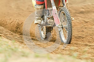 Motocross racer accelerating speed in track