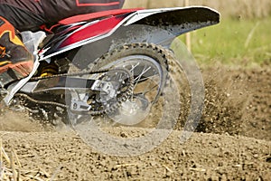 Motocross racer accelerating speed in track