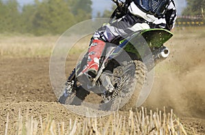 Motocross racer accelerating speed in track