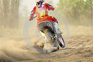 Motocross racer accelerating speed in track