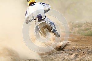 Motocross racer accelerating speed in track