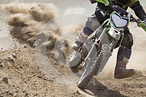 Motocross racer accelerating speed in track