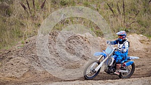 Motocross racer on dirt bike at sport track