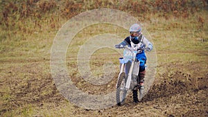 Motocross racer on dirt bike at sport track - fast and danger