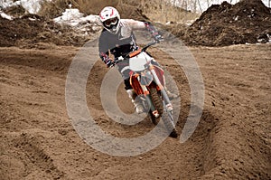 Motocross racing driver at turning photo