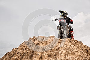 Motocross rider on his bike ready to race in dirt track