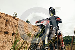 Motocross rider on his bike ready to race in dirt track