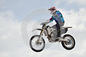 Motocross rider jump blue sky
