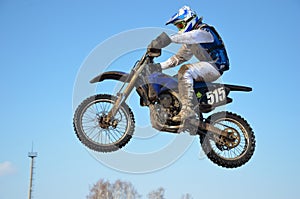 Motocross rider jump, blue sky