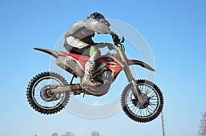 Motocross rider jump, blue sky