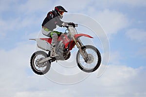 Motocross rider jump, blue sky