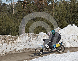 Motocross rider on a motorcycle on the race track in winter in the city of Noyabrsk, Yamalo-Nenets Autonomous District