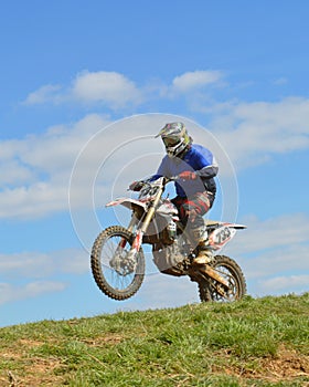 Motocross: the rider on top of a hill