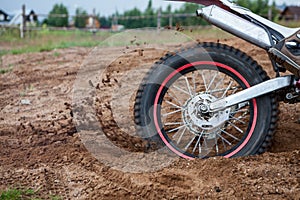 Motocross riding in sandy race track, rear spin wheel of dirtbike