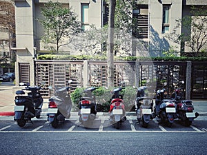 motocycle park in straight line , tidy on the road in the city