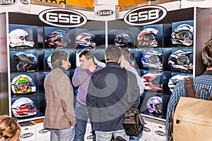 Motopark-2015 (BikePark-2015). The exhibition stand of GSB shop. The Showcase with helmets. Visitors are choose a helmet.