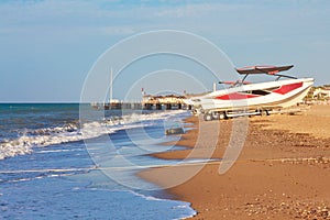 Motor boat on the beach near the sea in sunny weather