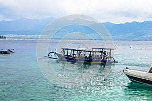 Motor Boat with divers, sails from the beach of Gili Meno island. Indonesia